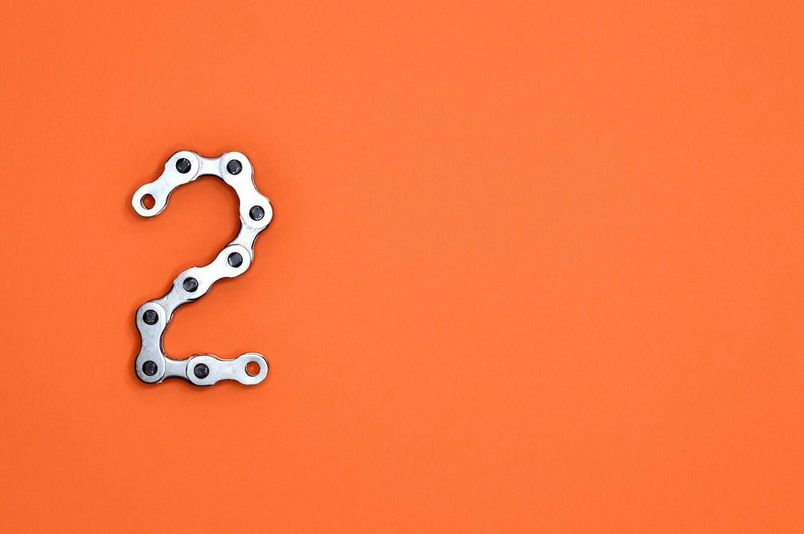 gray steel chain on orange surface